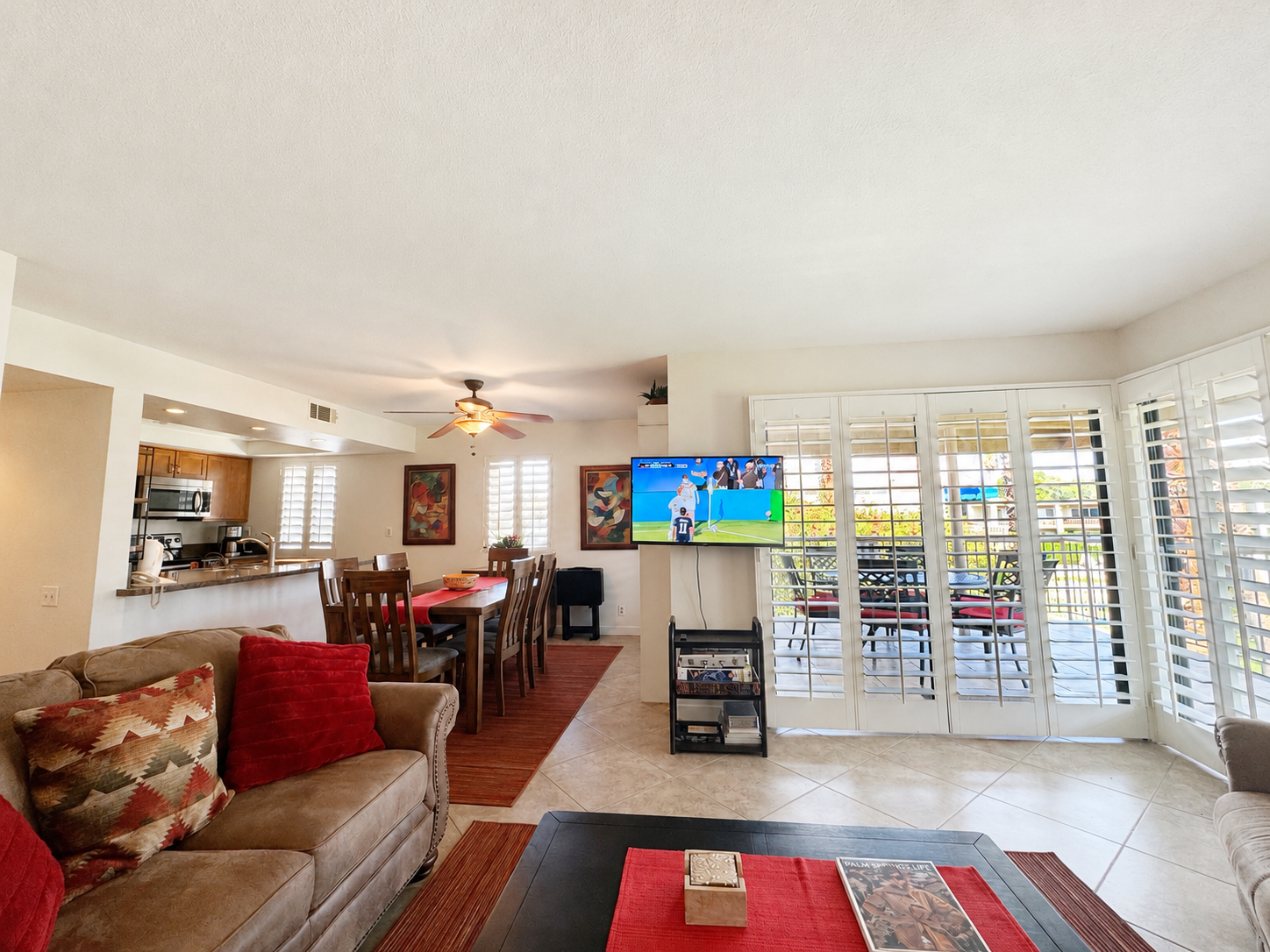 Open-concept living room facing the dining area and patio